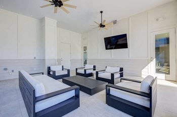Covered outdoor lounge area by pool